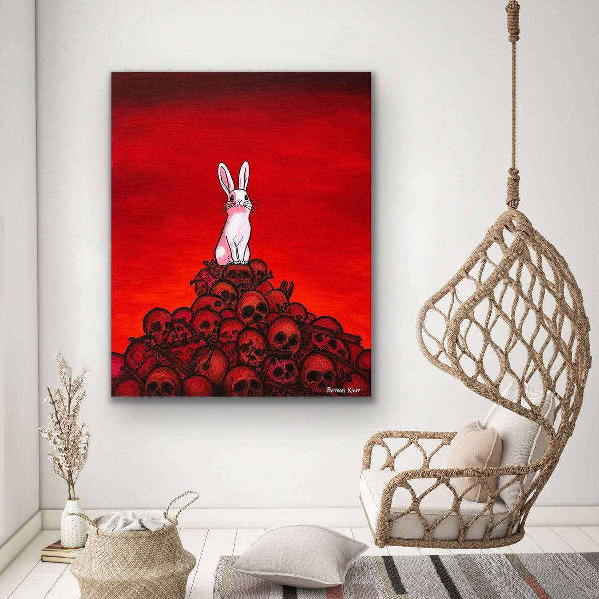 The Rabbit Among Skulls Art Print featuring a white rabbit atop a pile of skulls against a red background.