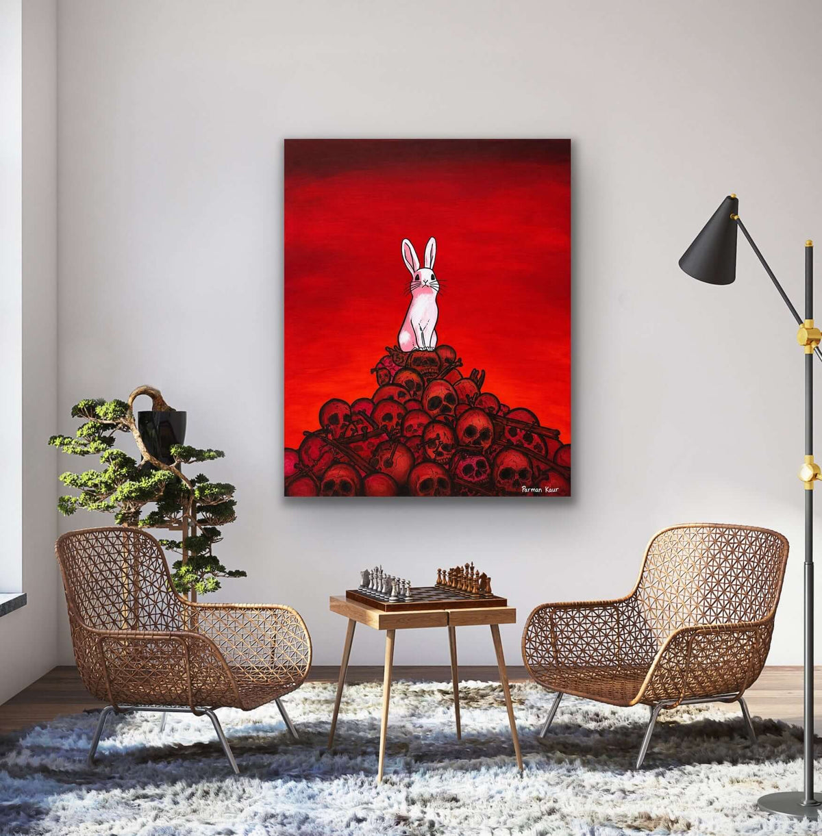 The Rabbit Among Skulls Art Print displayed in a modern living room, featuring a white rabbit above black skulls on a red background.